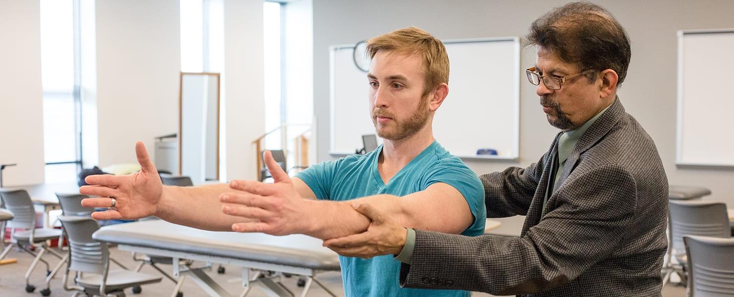 Physical therapy instructor working with student